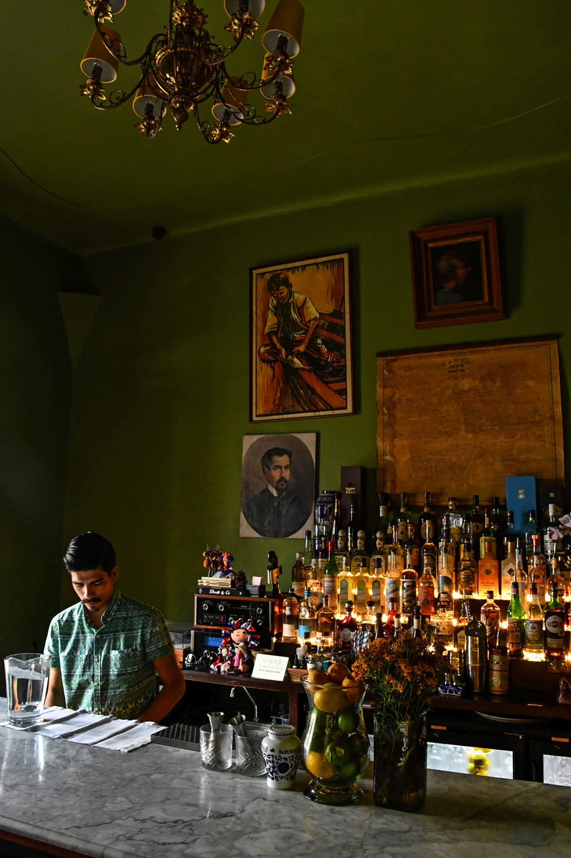 As I was checking out the new Hotel Amparo, I glimpsed the deep green walls of the bar, then young bartender Gabriel Avila in a dramatic sidelight. I introduced myself, heard his story about moving from Tijuana and made a dozen pictures. My favorite was shot up close from the side. The Times photo editors liked this vertical better.